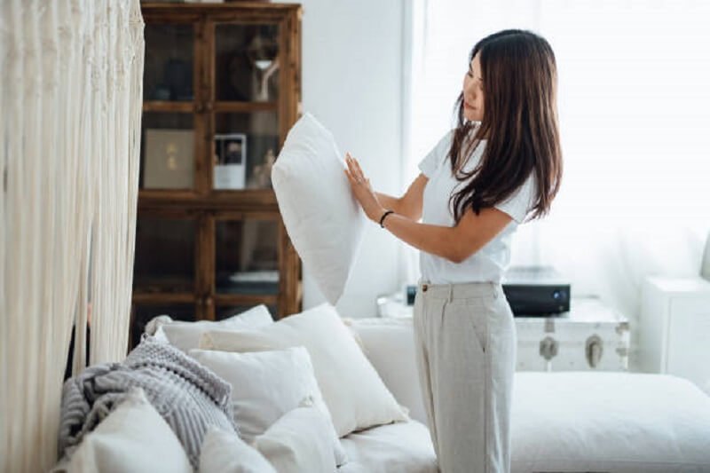 Woman cleaning cushion