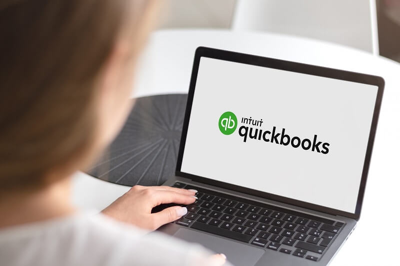 woman using QuickBooks on laptop