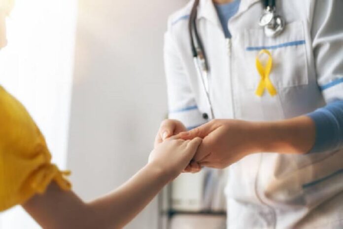 Doctor holding the hand of a cancer patient
