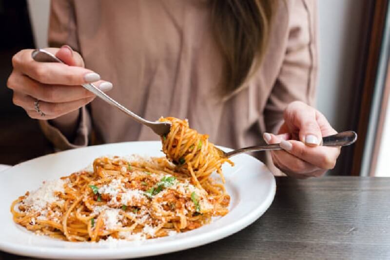 Girl eating Italian Pasta