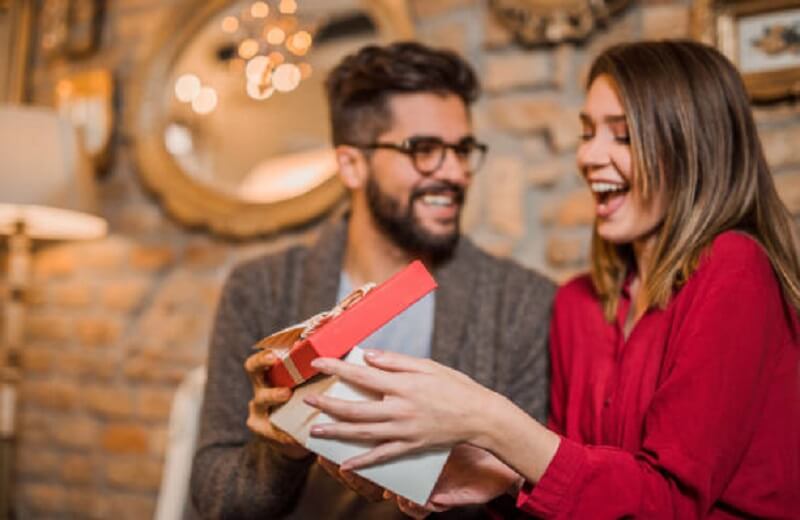 Man giving a gift to woman
