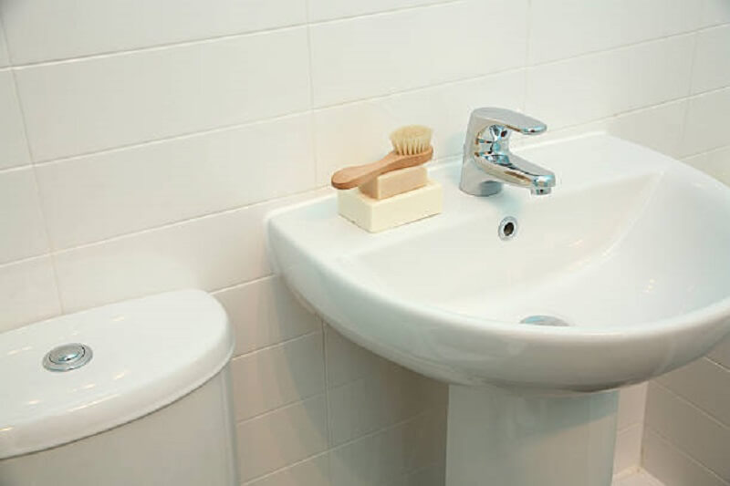 Cloakroom Taps on a white basin