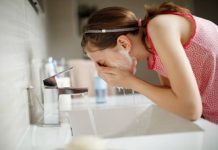 Girl washing her face with soap