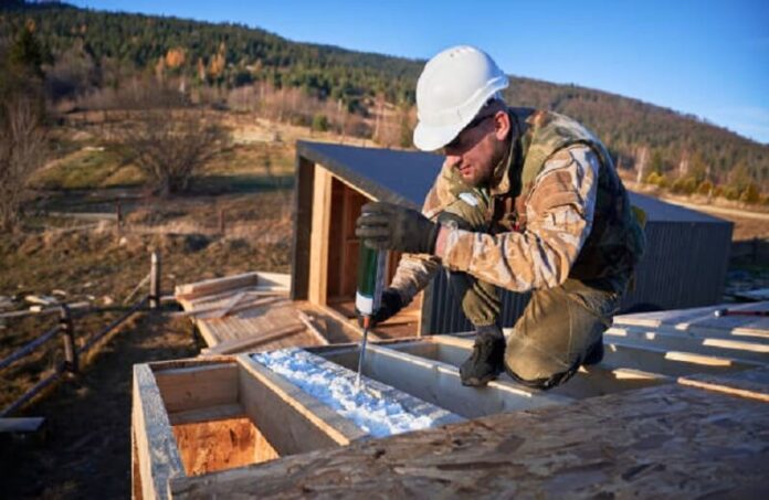 Man applying Insulated Roof Panels