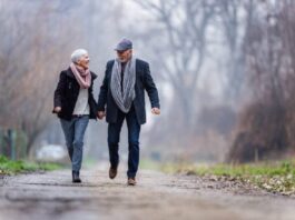 old couple walking on a road