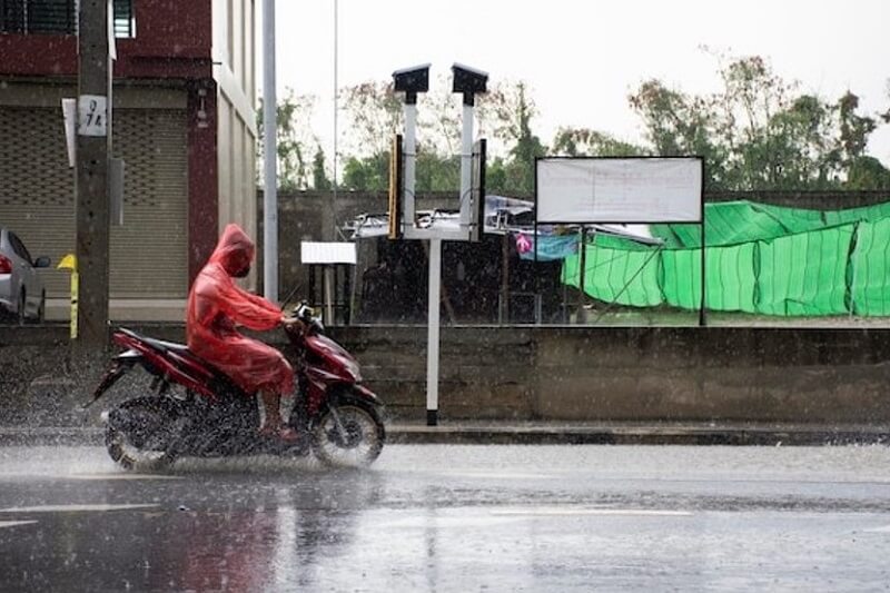man-rides-on-bike-in-rain