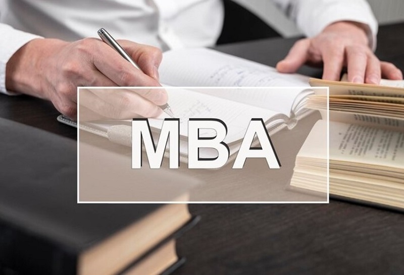 mba logo and man writeson paper