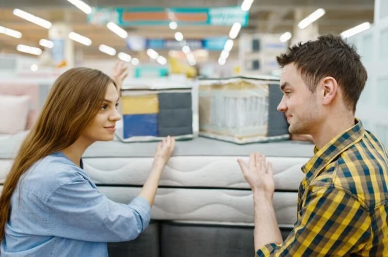 young couple buying in mattresses