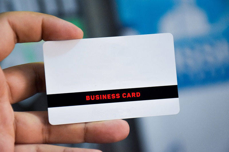 man-hand-holding-business-card