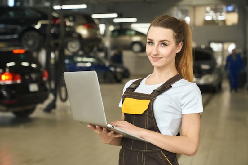 young mechanic girl hand holding a laptop