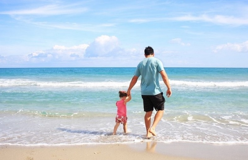Father and daughter enjoy beach sight