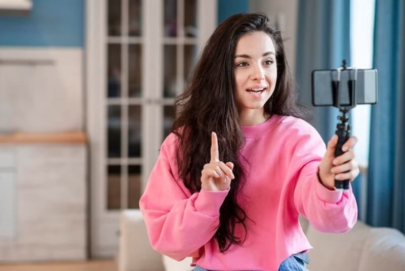 girl-making-her-video-by-using-selfie-stick