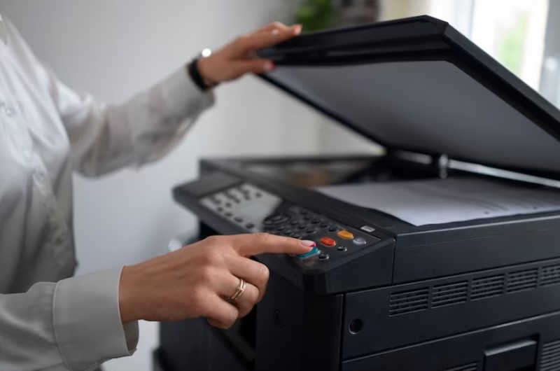 girl-using-printer-in-hand-press-button