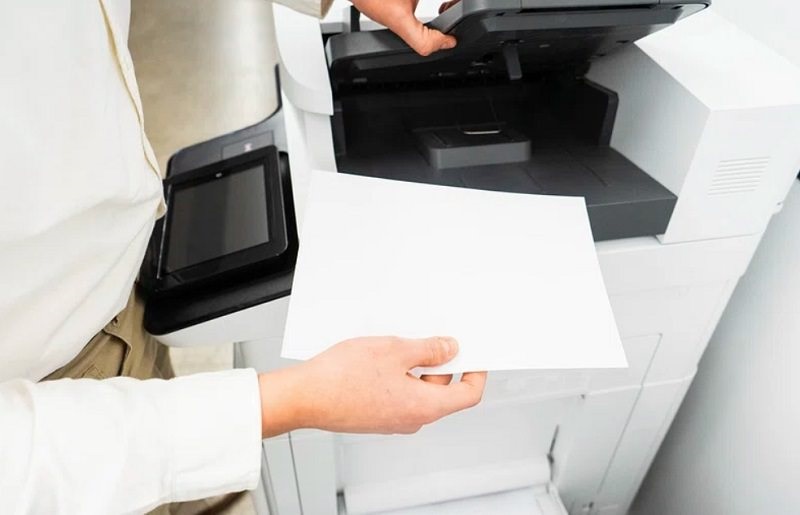 man-insert-the-paper-in-printer