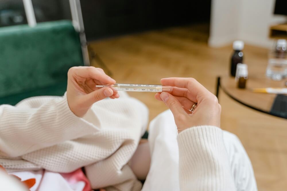 person holding thermometer